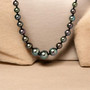 tahitian pearl graduated 7-12mm with 950 platinum clasp 18" shown in a lifestyle photo