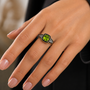 peridot with meteorite inlay and black spinel halo ring in 18k vermeil yellow gold and black rhodium prong tips over sterling silver on hand model