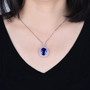 tanzanite and diamond double halo 18k white gold ring convertible necklace worn around the neck