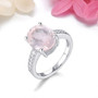 oval rose quartz and white zircon ring in rhodium over sterling silver shown in a lifestyle photo