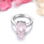 side view of oval rose quartz and white zircon ring in rhodium over sterling silver