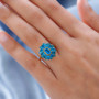 neon blue apatite cluster ring in 18k yellow gold over sterling silver worn on a hand