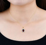 garnet and white zircon halo pendant necklace in 18k yellow gold over sterling silver worn around the neck