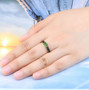 chrome diopside and black spinel band ring in black rhodium and 18k yellow gold over sterling silver worn on a hand