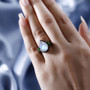 moonstone chrome diopside and black spinel pear halo ring in rhodium over sterling silver worn on a hand