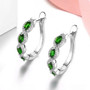 chrome diopside and white zircon hoops in rhodium over sterling silver shown in a lifestyle photo