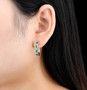 chrome diopside and white zircon hoops in rhodium over sterling silver shown being worn