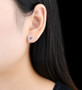 pink tourmaline and white zircon round halo stud earrings in rhodium over sterling silver worn on the ear