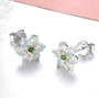 ethiopian opal and chrome diopside cluster stud earrings in rhodium over sterling silver shown in a lifestyle photo