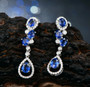 blue sapphire and diamond 14k white gold dangle earrings shown in a lifestyle photo