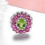 pink tourmaline peridot and zircon halo cluster ring in rhodium over sterling silver shown in a lifestyle photo