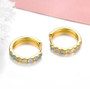 close up of ethiopian opal cabochon hoops in 18k yellow gold over sterling silver