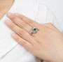 chrome diopside flower ring in rhodium over sterling silver worn on a hand
