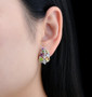 multi gemstone leaf earrings in rhodium over sterling silver worn on the ear