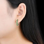 chrome diopside and white zircon hoops in rhodium over sterling silver shown being worn