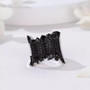 black spinel wide band cluster ring in rhodium over sterling silver shown in a lifestyle photo