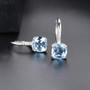 side view of sky blue topaz cushion earrings in rhodium over sterling silver