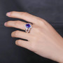 close up of tanzanite and diamond bypass ring in 18k white gold