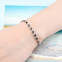 garnet bracelet in rhodium over sterling silver worn on a wrist