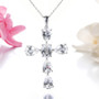 white topaz cross necklace in rhodium over sterling silver shown in a lifestyle photo
