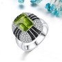 peridot black spinel and white zircon statement ring in rhodium over sterling silver shown in a lifestyle photo