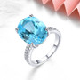 swiss blue topaz and white zircon ring in rhodium over sterling silver shown in a lifestyle photo