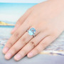 swiss blue topaz and white zircon ring in rhodium over sterling silver worn on a hand