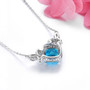 back view of swiss blue topaz and white zircon station necklace in rhodium over sterling silver
