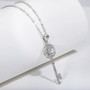 close up of moissanite key pendant necklace in rhodium over sterling silver