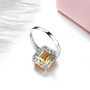 close up of citrine and emerald cut and white zircon halo ring in rhodium over sterling silver