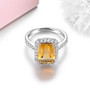 front view of citrine and emerald cut and white zircon halo ring in rhodium over sterling silver
