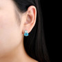 swiss blue topaz opal and zircon stud earrings in rhodium over sterling silver worn on the ear
