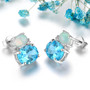 side view of swiss blue topaz opal and zircon stud earrings in rhodium over sterling silver