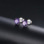 amethyst 7x5mm cushion cut stud earrings in rhodium over sterling silver shown in a lifestyle photo