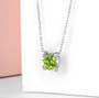 peridot 7mm round solitaire floating pendant necklace in rhodium over sterling silver shown in a lifestyle photo