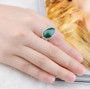 malachite pear solitaire ring in rhodium over sterling silver worn on a hand