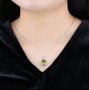 peridot cushion and white zircon halo pendant necklace in rhodium over sterling silver worn around the neck