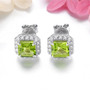 square cut peridot and white zircon halo stud earrings in rhodium over sterling silver shown in a lifestyle photo