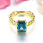 front view of london blue topaz chain link solitaire ring in 18k yellow gold over sterling silver