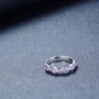 angled view of tanzanite wavy band ring in rhodium over sterling silver