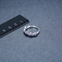 tanzanite wavy band ring in rhodium over sterling silver shown for size comparison