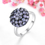 tanzanite round cluster ring in black and white rhodium over sterling silver shown in a lifestyle photo