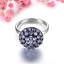 front view of tanzanite round cluster ring in black and white rhodium over sterling silver