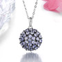 tanzanite round cluster pendant necklace in black and white rhodium over sterling silver shown in a lifestyle photo
