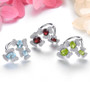 close up of sky blue topaz openwork flower ring in rhodium over sterling silver