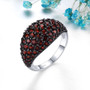 domed garnet band ring in black and white rhodium over sterling silver shown in a lifestyle photo