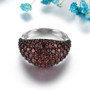 front view of domed garnet band ring in black and white rhodium over sterling silver