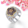 garnet citrine and white zircon flower ring in 18k yellow gold and rhodium over sterling silver shown in a lifestyle photo