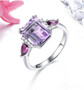 amethyst rhodolite garnet and white zircon ring in rhodium over sterling silver shown in a lifestyle photo