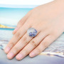tanzanite and white zircon ring in rhodium over sterling silver worn on a hand